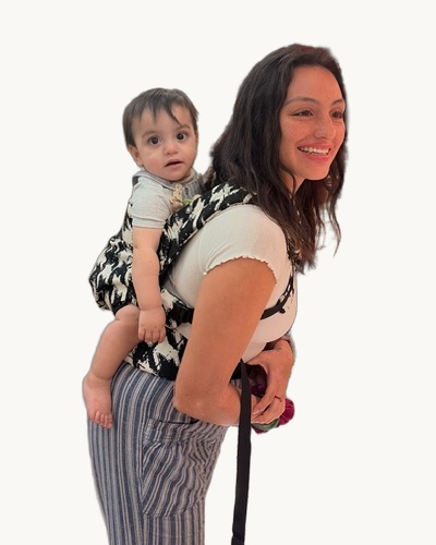 Jewelyssa smiling while carrying her young son on her back